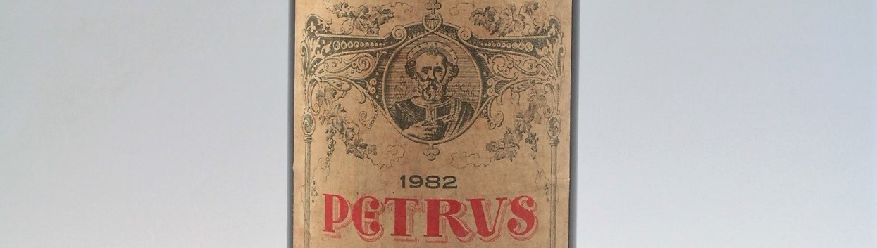 The picture shows a grand cru bottle of Chateau Petrus wine from Bordeaux